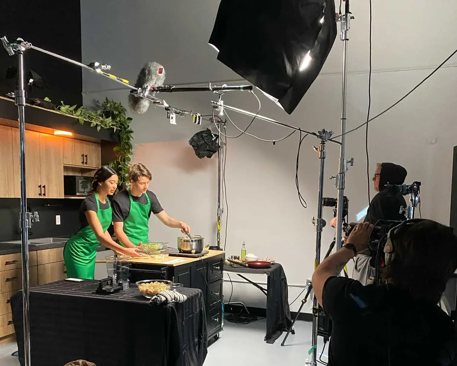 Camera, lighting and sound crew filming a production scene