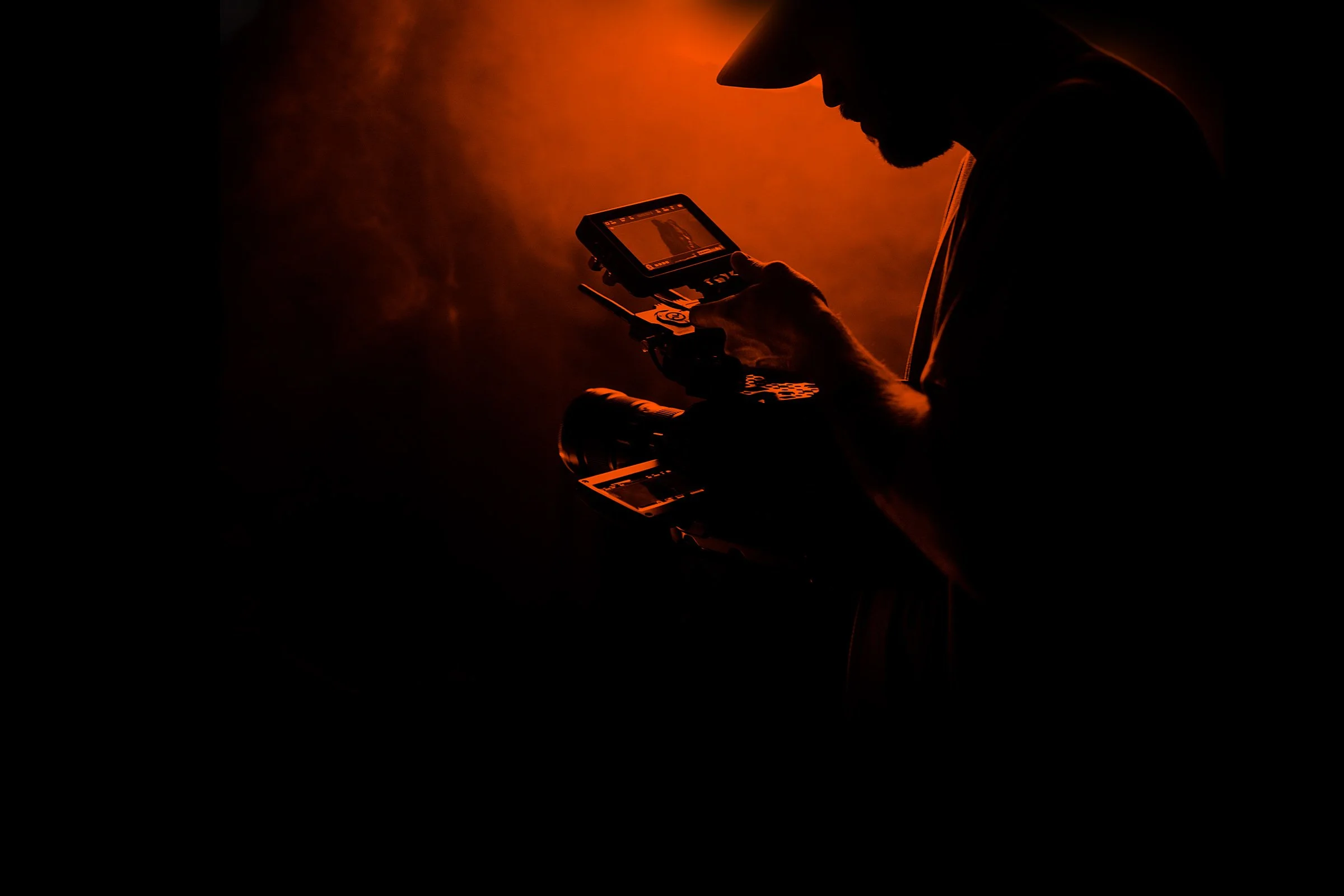 A camera operator reviewing a shot on set