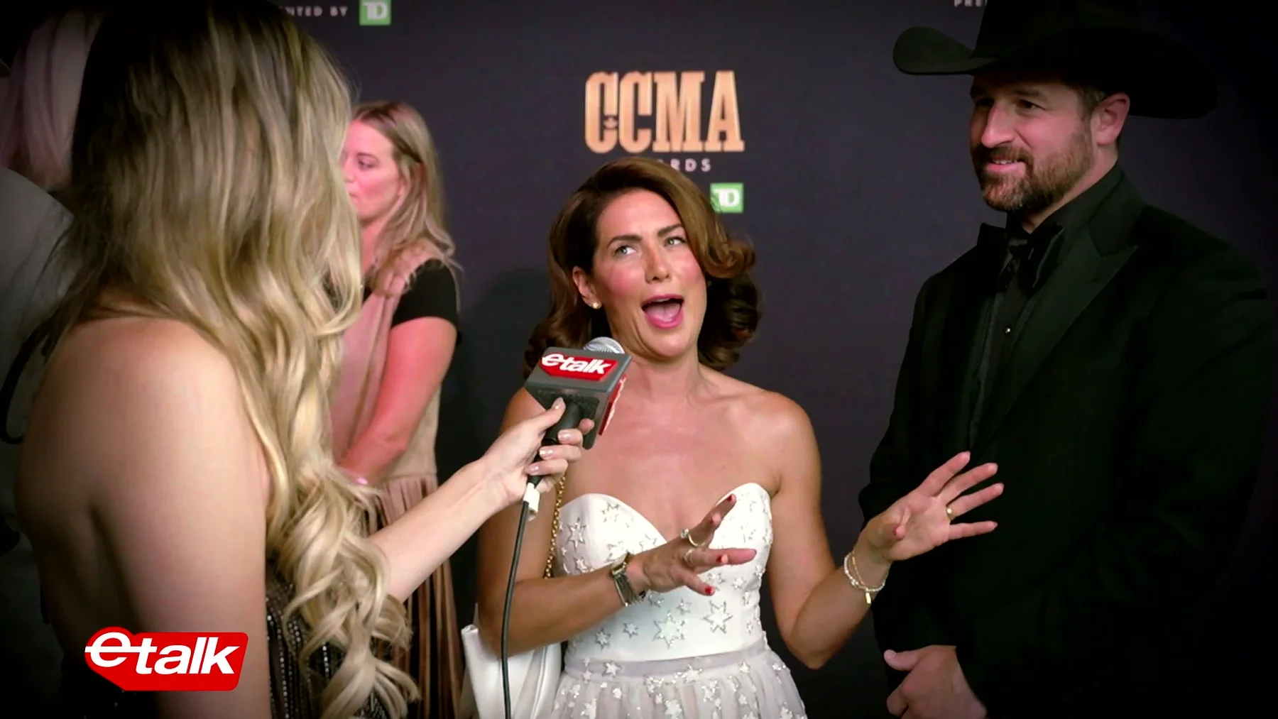 eTalk interviewer speaking with two guests on the CCMA red carpet