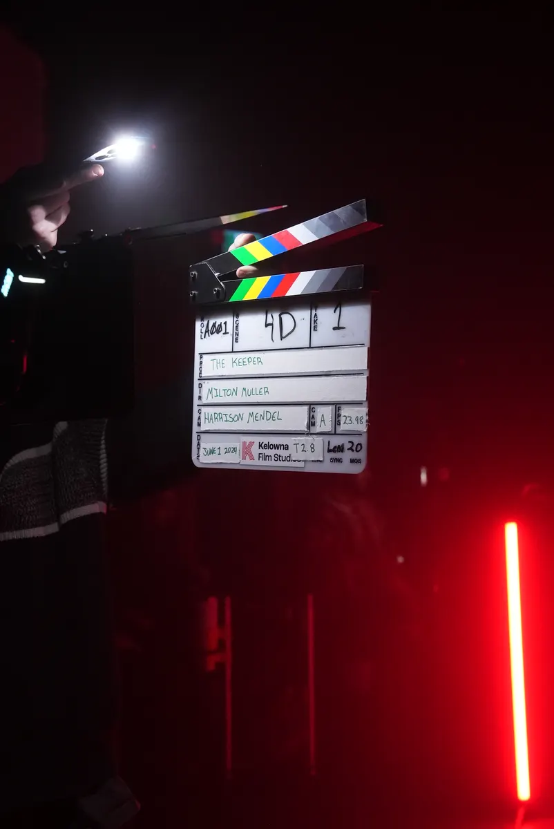 Slate on The Keepers set with red production lighting