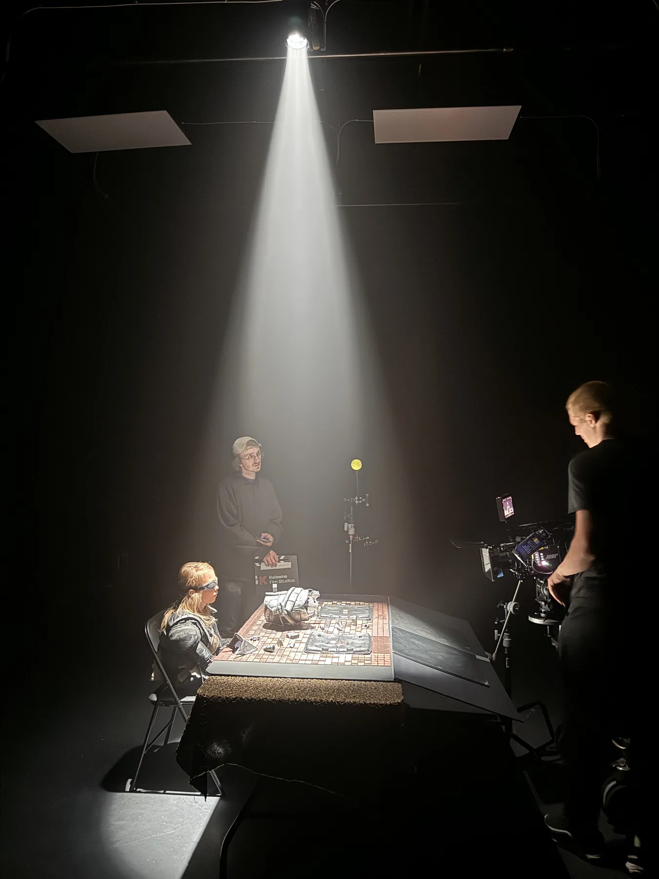 Overhead table setup with actor, slate and camera during The Keepers production