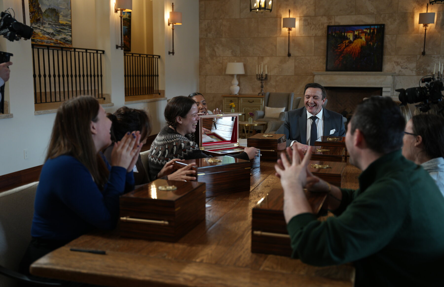 Peter Serafinowicz and Million Dollar Secret contestants around an EPK table at Chateau Okanagan