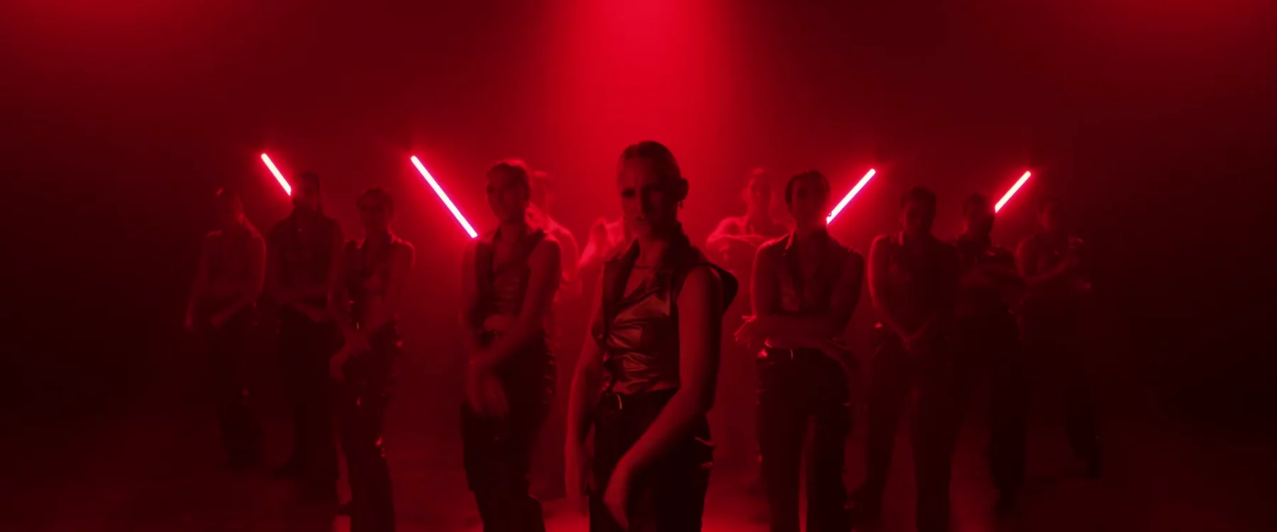 Sockeye dancer leading a red-lit formation in the 2024 film