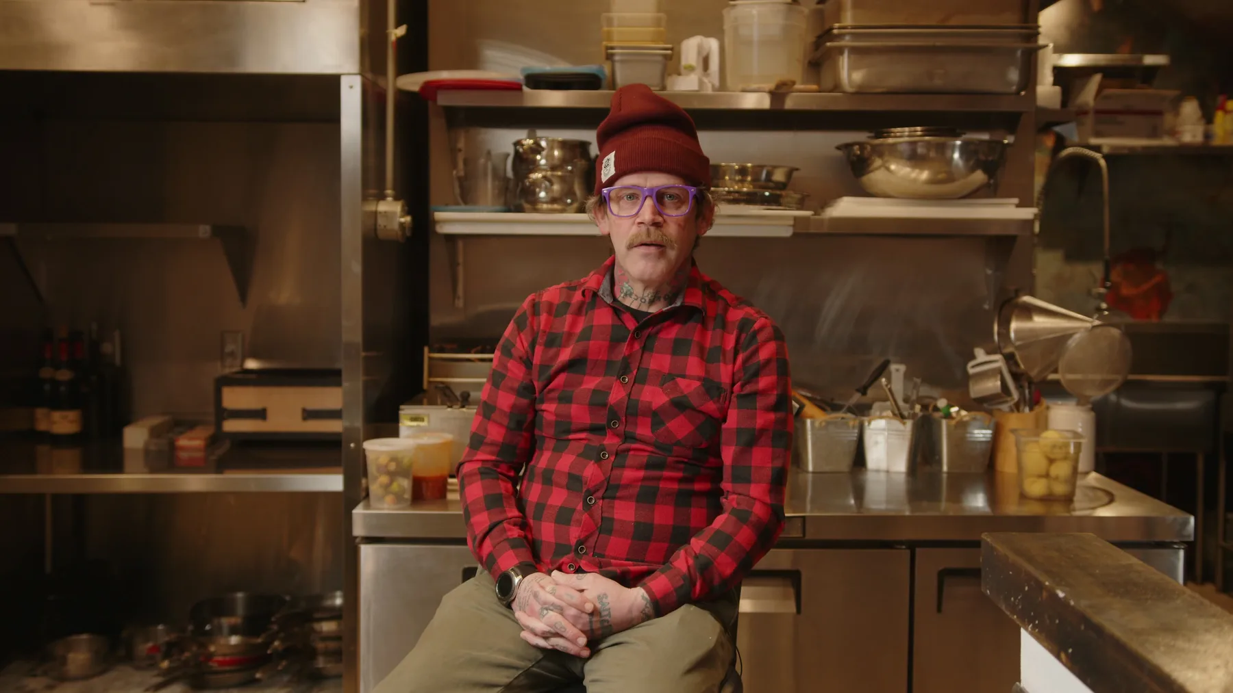 Bob Blumer seated in a working kitchen during Vintage Rebel development footage.